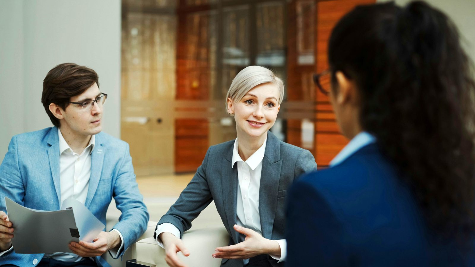 A Jude & Magnolia attorney talking with a client in the firm’s office